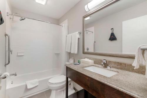 a bathroom with a sink and a toilet and a mirror at Best Western York Inn in York