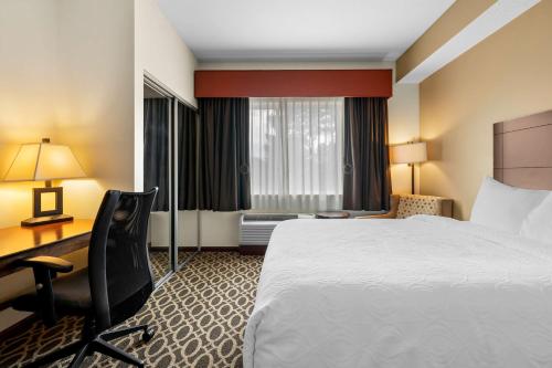 a hotel room with a bed and a desk at Best Western Paradise Inn in Savoy