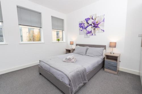 a white bedroom with a bed and two windows at Cosy 1Bed Getaway in Central Hull in Hull