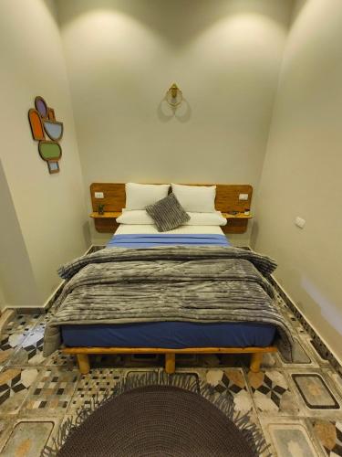 a bedroom with a bed with a wooden head board at Champollion Palace in Cairo
