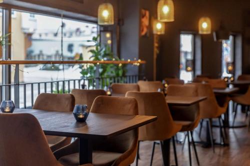 a row of tables and chairs in a restaurant at Best Western Plus Grand Hotel Elektra in Ludvika