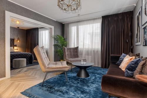 a living room with a couch and a table at Best Western Plus Grand Hotel Elektra in Ludvika