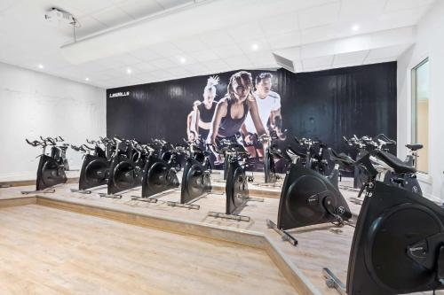 a gym with rows of exercise bikes in a room at Best Western Plus Grand Hotel Elektra in Ludvika