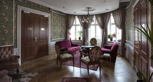 a living room with purple chairs and a table at Hotel Kung Carl, WorldHotels Crafted in Stockholm