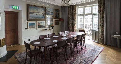 a dining room with a table and chairs at Hotel Kung Carl, WorldHotels Crafted in Stockholm