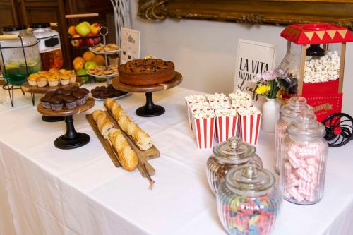 a table with various pastries and desserts on it at Best Western Madison Hotel in Milan