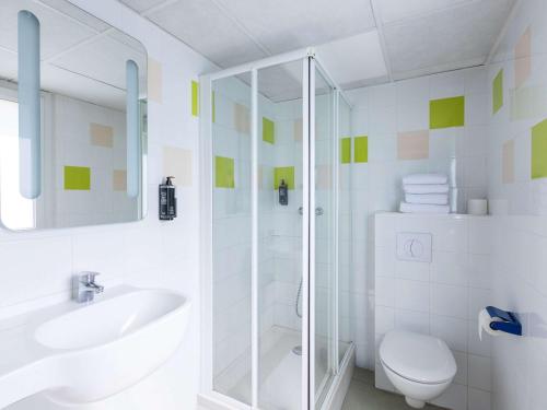 a bathroom with a shower and a toilet and a sink at ibis budget Angoulême Centre in Angoulême