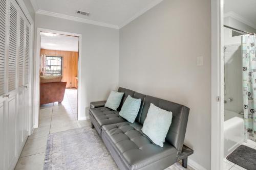 a living room with a couch with blue pillows at Spacious Little Rock Home with Patio - 9 Mi to Dtwn! in Little Rock