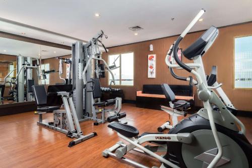 a gym with treadmills and elliptical machines at Best Western Plus Makassar Beach in Makassar