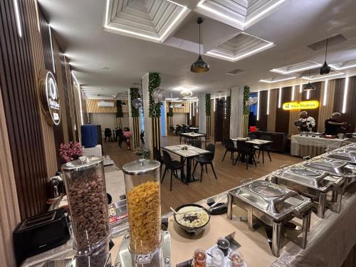 a restaurant with tables and chairs and tablesablishbestosbestosbestosbestosbestosbestosbestos at New Hotel Suhail in Hyderabad