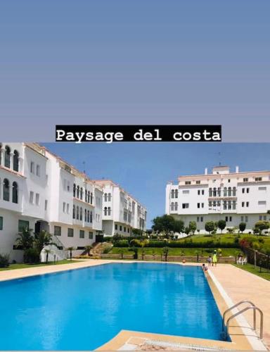 a large swimming pool in front of some buildings at appartement de vacances achakar plage & piscine & wifi in Tangier