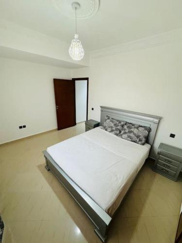 a bedroom with a large bed in a room at appartement de vacances achakar plage & piscine & wifi in Tangier