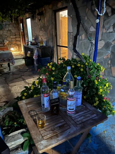 a wooden table with bottles and glasses on it at Mountain Villa in Maries