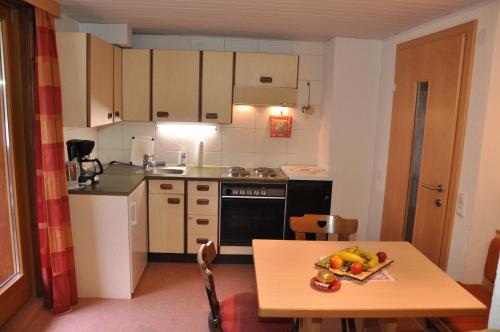 a small kitchen with a table with fruit on it at Ferienwohnung Artur Wieser in Sankt Jakob in Defereggen