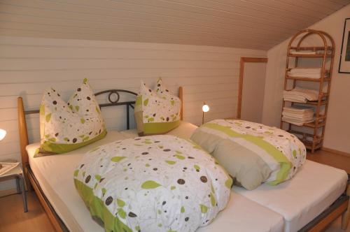 a bedroom with two beds with pillows and a ladder at Ferienwohnung Artur Wieser in Sankt Jakob in Defereggen
