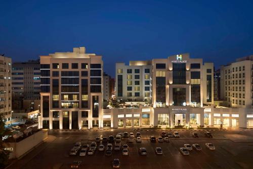 a parking lot in front of a building at night at Hyatt Place Dubai Al Rigga in Dubai