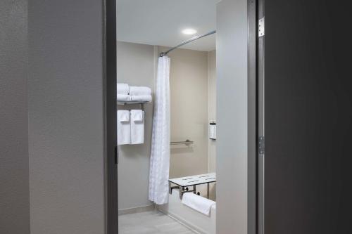 a bathroom with white towels and a shower at Hyatt Place Columbus/Dublin in Dublin