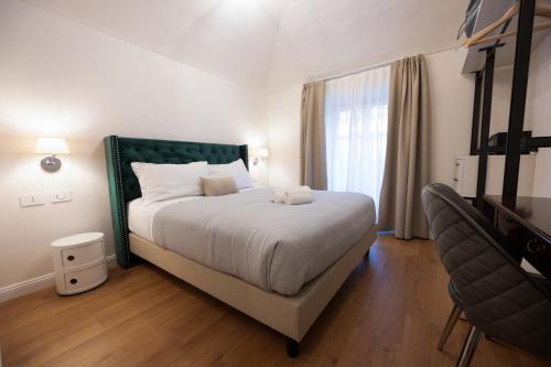 a bedroom with a large bed and a window at Carlo Felice Boutique Hotel in Turin