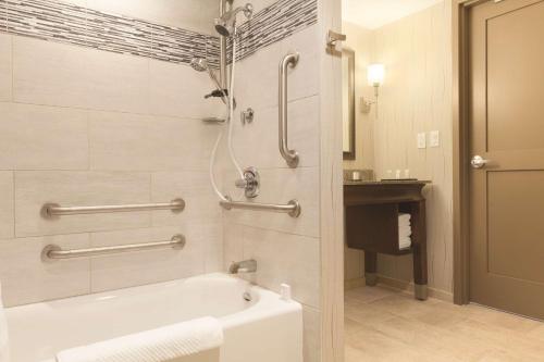 a bathroom with a bath tub and a shower at Embassy Suites Saratoga Springs in Saratoga Springs