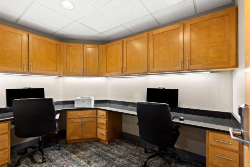 an office with wooden cabinets and desks and chairs at Hampton Inn & Suites Canton in North Canton