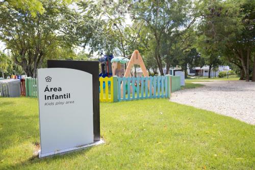 a sign in front of a playground in a park at Ka' Romana Residences in El Soco