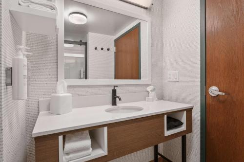 a bathroom with a sink and a mirror at Hampton Inn & Suites Lake George in Lake George