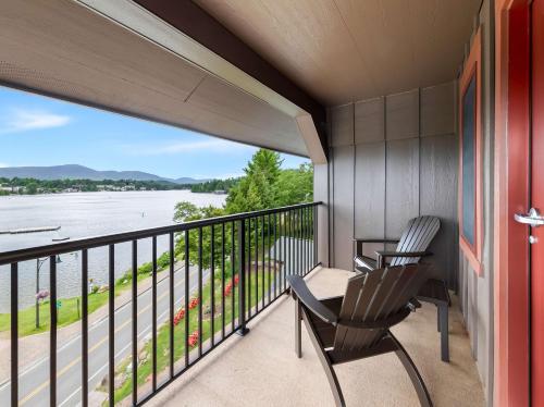 two chairs on a balcony with a view of the water at Hampton Inn & Suites Lake Placid in Lake Placid