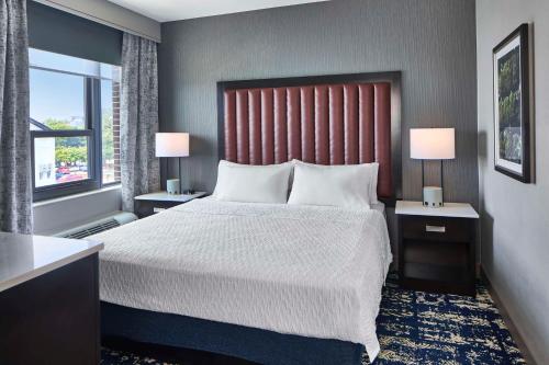 a bedroom with a large bed and a window at Homewood Suites Savannah Historic District/Riverfront in Savannah