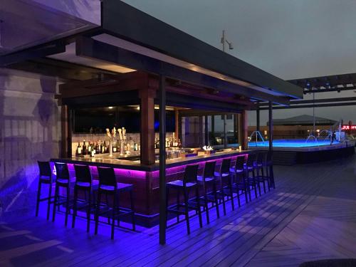 a bar on a deck with purple lighting at Homewood Suites Savannah Historic District/Riverfront in Savannah
