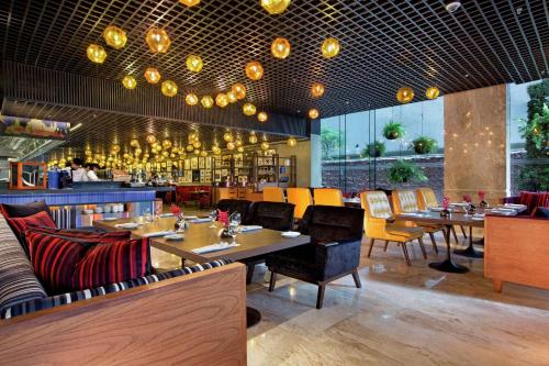 a restaurant with tables and chairs and a bar at DoubleTree by Hilton Sukhumvit Bangkok in Bangkok