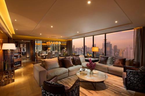 a living room with a couch and a table at Hilton Sukhumvit Bangkok in Bangkok