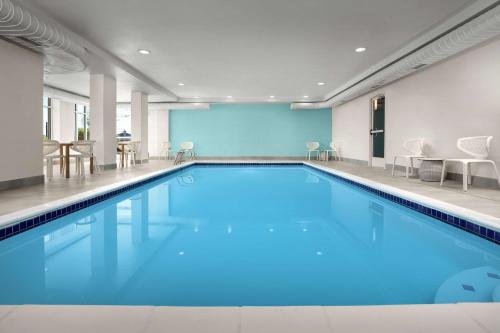a large pool with blue water in a building at Hilton Garden Inn Colorado Springs North in Colorado Springs