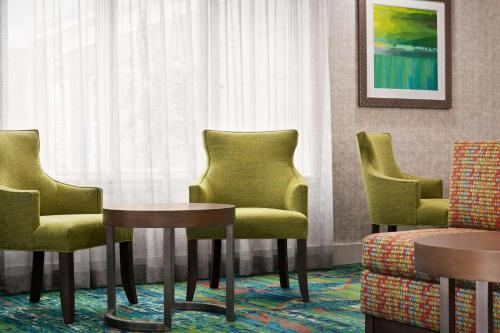a waiting room with four chairs and a table at Homewood Suites by Hilton Fort Myers in Fort Myers