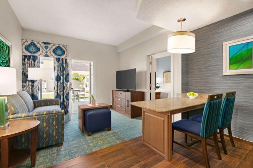 a living room with a kitchen and a dining room at Homewood Suites by Hilton Fort Myers in Fort Myers