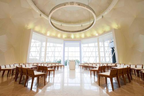 a large room with tables and chairs in it at Hilton Fukuoka Sea Hawk in Fukuoka