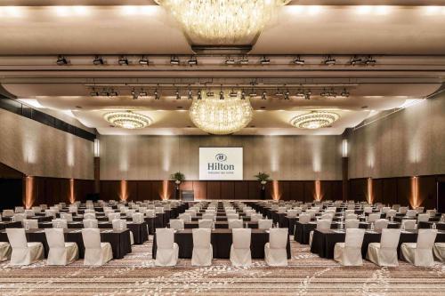 a large room with rows of tables and chairs at Hilton Fukuoka Sea Hawk in Fukuoka