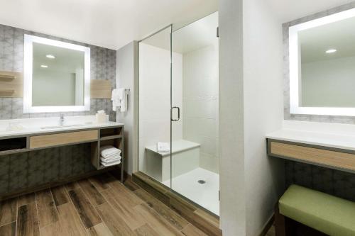 a bathroom with a shower and a sink at Hilton Garden Inn Greenville in Greenville
