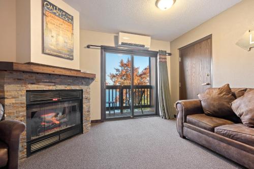 a living room with a couch and a fireplace at Cragun's Resort on Gull Lake in Brainerd