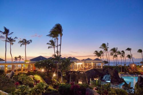 a view of a resort with a pool and palm trees at Hilton Waikoloa Village in Waikoloa
