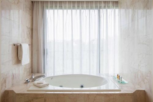 a bath tub in a bathroom with a window at Hilton Waikoloa Village in Waikoloa
