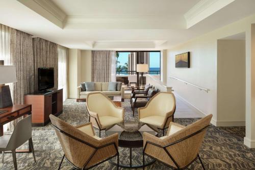 a living room with a couch and a table and chairs at Hilton Waikoloa Village in Waikoloa