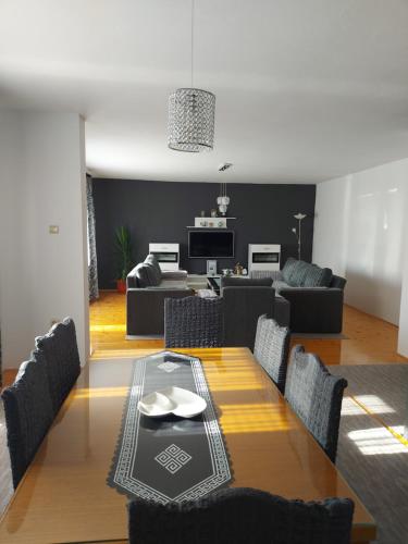 a dining room with a table and a living room at Apartmani" Irina 2" Pale in Pale