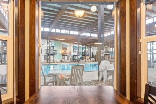 a dining room with a table and a bar at Cragun's Resort on Gull Lake in Brainerd