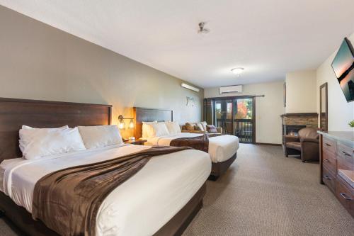a hotel room with two beds and a balcony at Cragun's Resort on Gull Lake in Brainerd