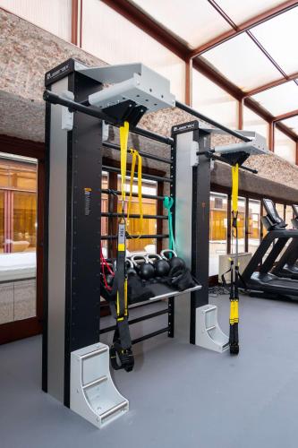 a gym with a simulator with weights at Hilton Madrid Airport in Madrid