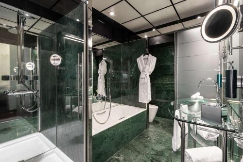 a bathroom with a shower and a toilet and a sink at Hilton Madrid Airport in Madrid