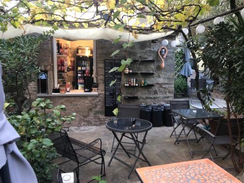 a patio with tables and chairs and a bar at Appartamento vacanze "Borgo Cinque Terre" Volastra Manarola in Volastra