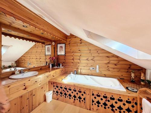 a bathroom with a large tub and two sinks at Chalet Les Elfes - Chalet Les Elfes — Luxe et confort pour un séjour MAE-7361 in Les Allues