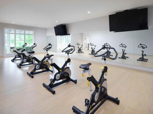 a row of exercise bikes in a gym at Embassy Suites by Hilton Myrtle Beach Oceanfront Resort in Myrtle Beach