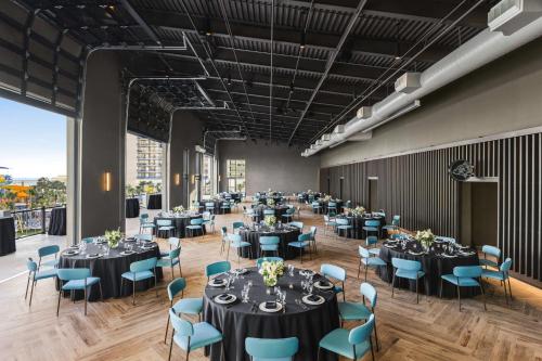 a large banquet hall with tables and blue chairs at Embassy Suites by Hilton Myrtle Beach Oceanfront Resort in Myrtle Beach